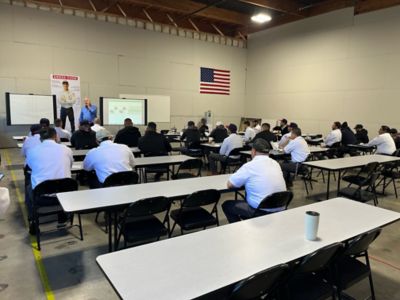 NexGen Employees listening to a speaker