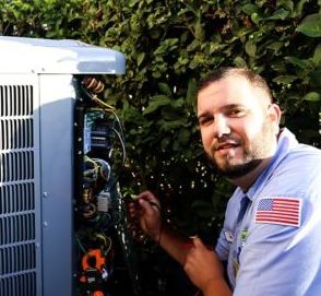 HVAC technician repairing an air conditioning unit