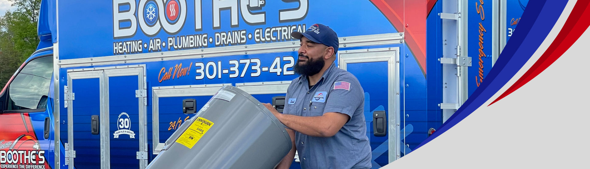 plumber walking with water heater in front of service truck