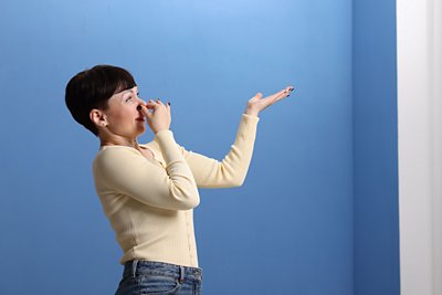 Woman holding her nose because of a musty air conditioning smell