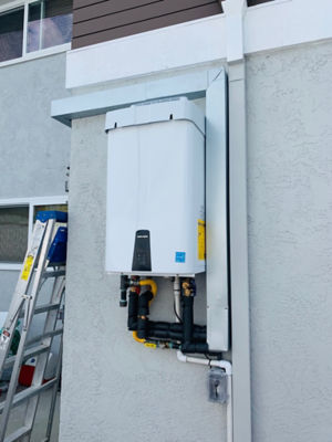 A navien tankless water heater outside of a house.