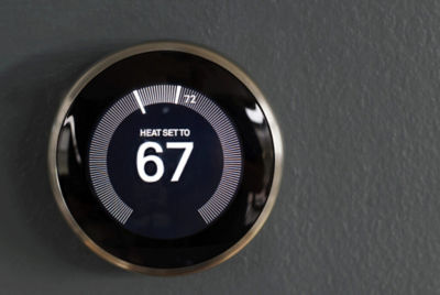 black thermostat with heat set to 67 degrees