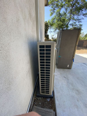 A cooling unit on the side of a building.