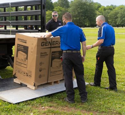 Three Coolray techs unloading a new generac generator from their truck