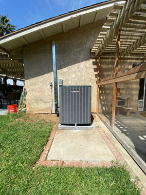 An AC unit connected to a building.