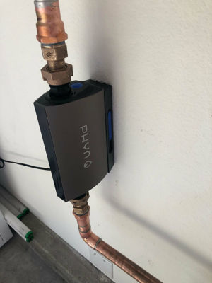 Tankless water heater attached to wall