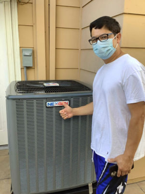 A happy man giving a thumbs up in front of a NexGen AC unit.