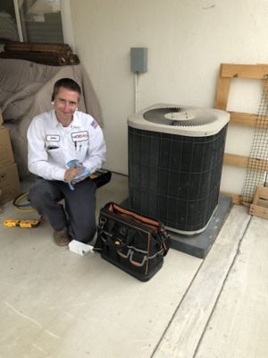 Smiling nexgen tech doing HVAC repair