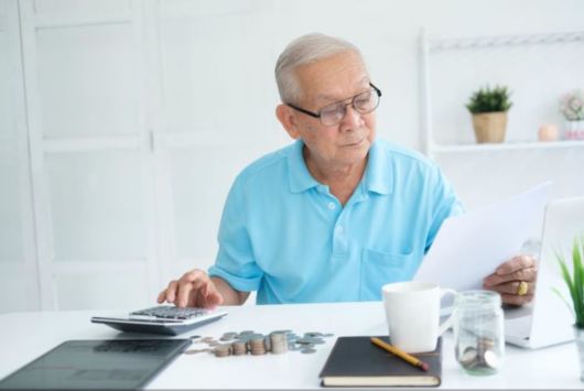 Old man calculating bills