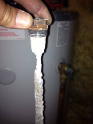 Hand on water heater anode
