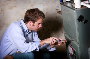 Technician opening furnace for repair