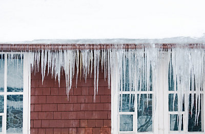 Icecycles hanging from roof of brick house
