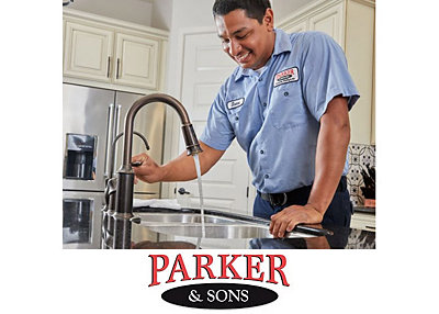 Plumber checking water pressure in a Tucson home