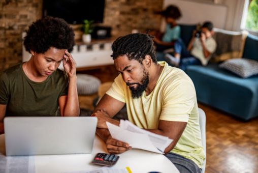 A person and person looking at papers