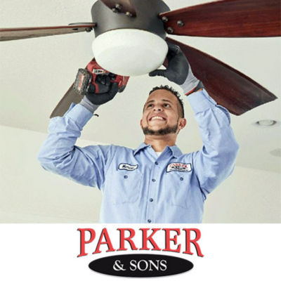 Electrician installing a fan in a Tucson home