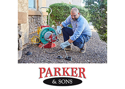 Plumber from Parker & Sons performing drain cleaning service at a Phoenix home