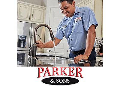 A plumber from Parker & Sons turning on a kitchen faucet