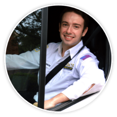 Technician, Paul sitting in a truck with a uniform shirt on