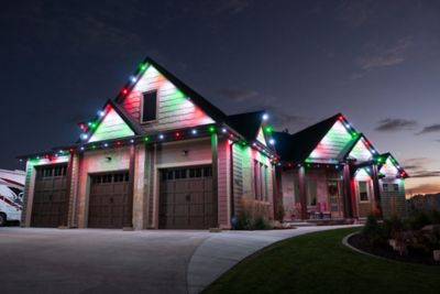 Home at nighttime with permanent Christmas lights