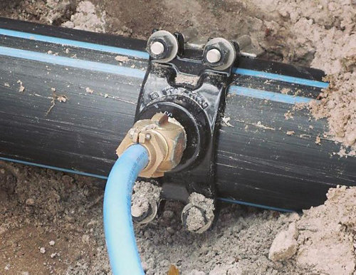 A pipe with a blue hose attached to it