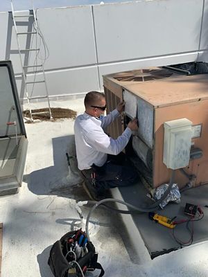 Technican working an commercial AC unit