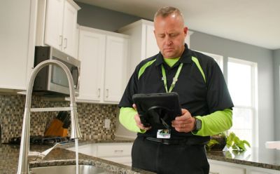 plumber at kitchen sink