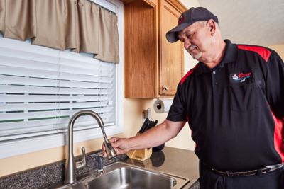 Plumber working on a kitchen sink