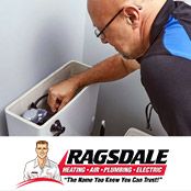 Plumber repairing a toilet