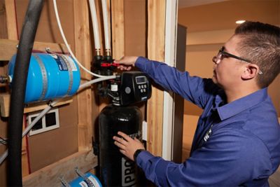 Plumbing expert in Salt Lake CIty installing a whole house water filter