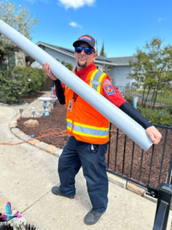 Plumber carrying a PVC pipe