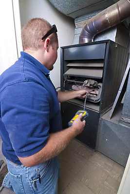 Plumber in front of furnace