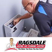 Plumber repairing a toilet in a Marietta, GA home