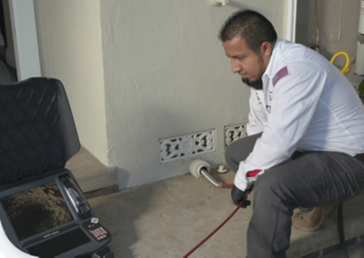 Plumber looking at the inside of pipes using camera