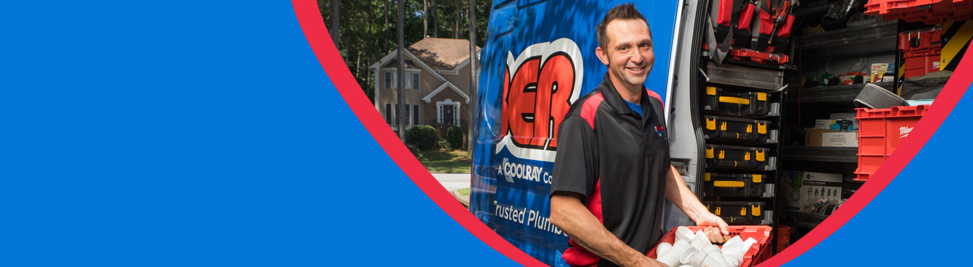 Plumber smiling next to equipment in van