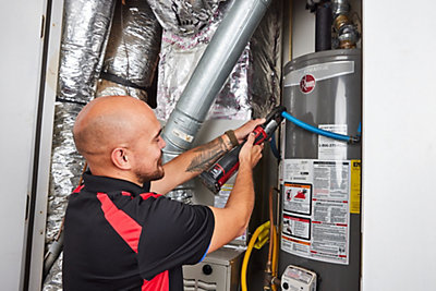 Plumber repairing a water heater in a Gainesville, GA home