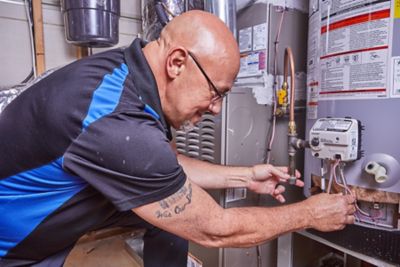 Plumber flushing a water heater in an Atlanta area home