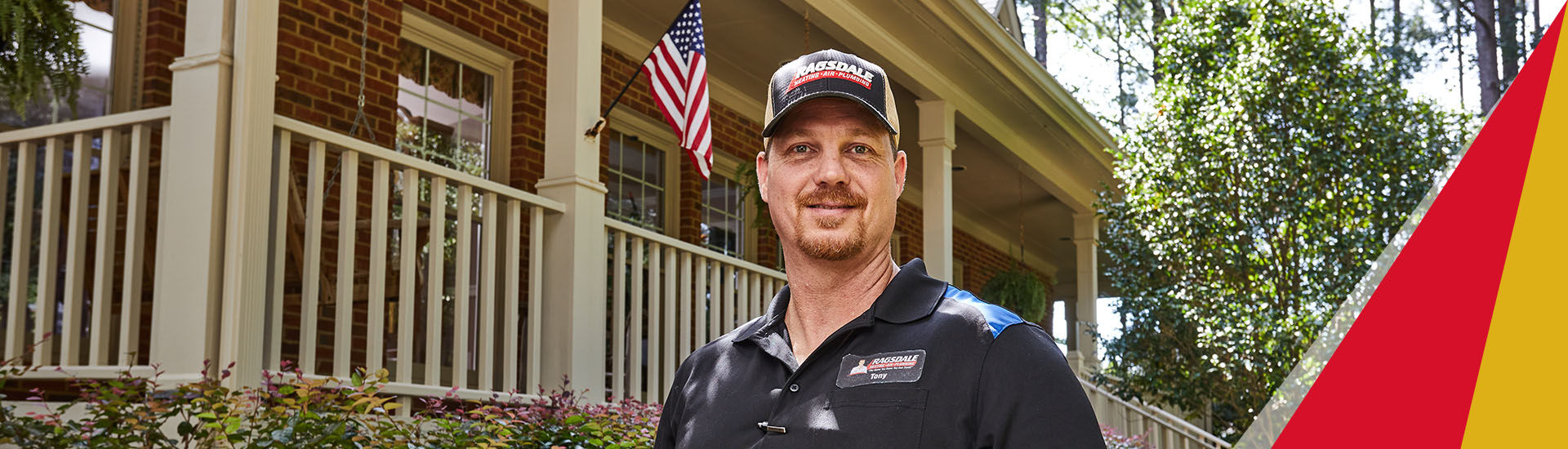Ragsdale technician smiling in front of house