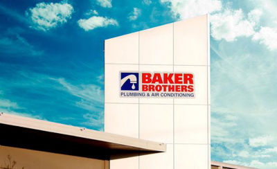 Baker Brothers sign at headquarters with blue sky in background