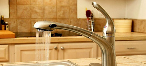 Kitchen faucet running water.