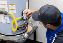A Coolray plumber inspecting a water heater