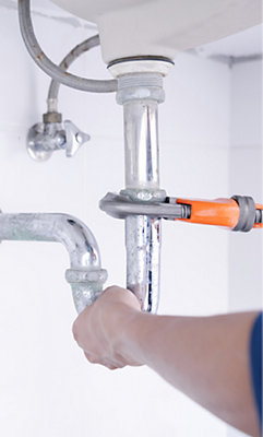 a close-up of a plumber fixing a pipe