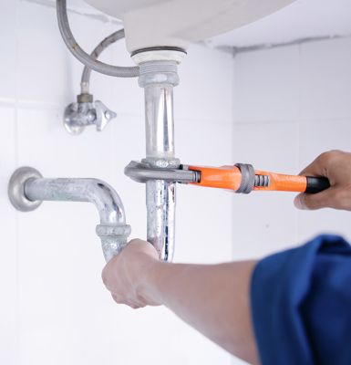 fixing-pipe-under-sink-with-wrench-DIY