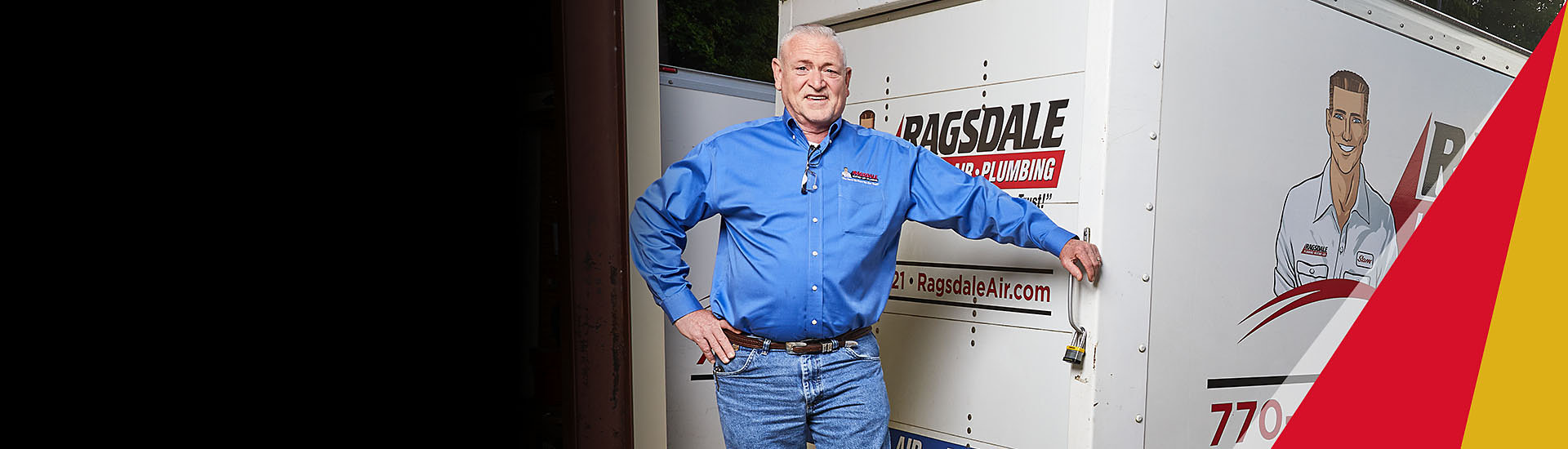Ragsdale employee standing behind truck smiling