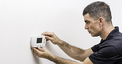 Man Installing Thermostat
