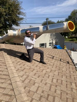 Tech holding pipe up on roof