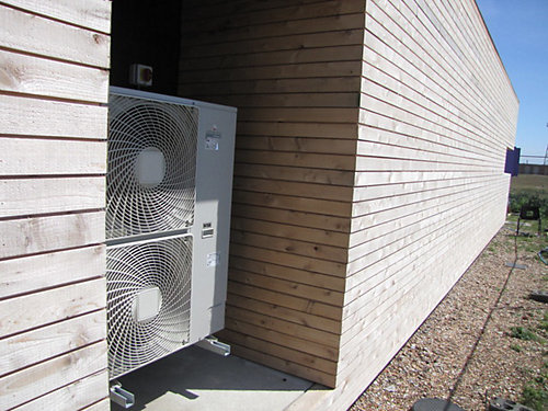 Heat Pumps on the back of a wood house 