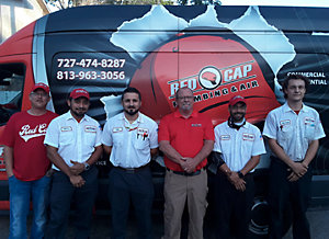 Group of men standing in front of a van
