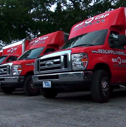 Branded Red Cap service vehicles parked next to each other 