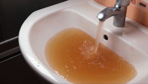 A water running from a faucet into a sink