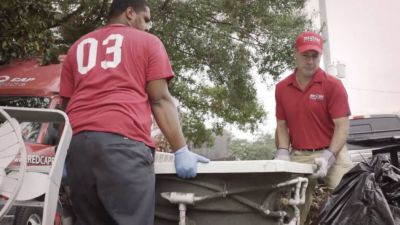 A group of men wearing red shirts and gloves